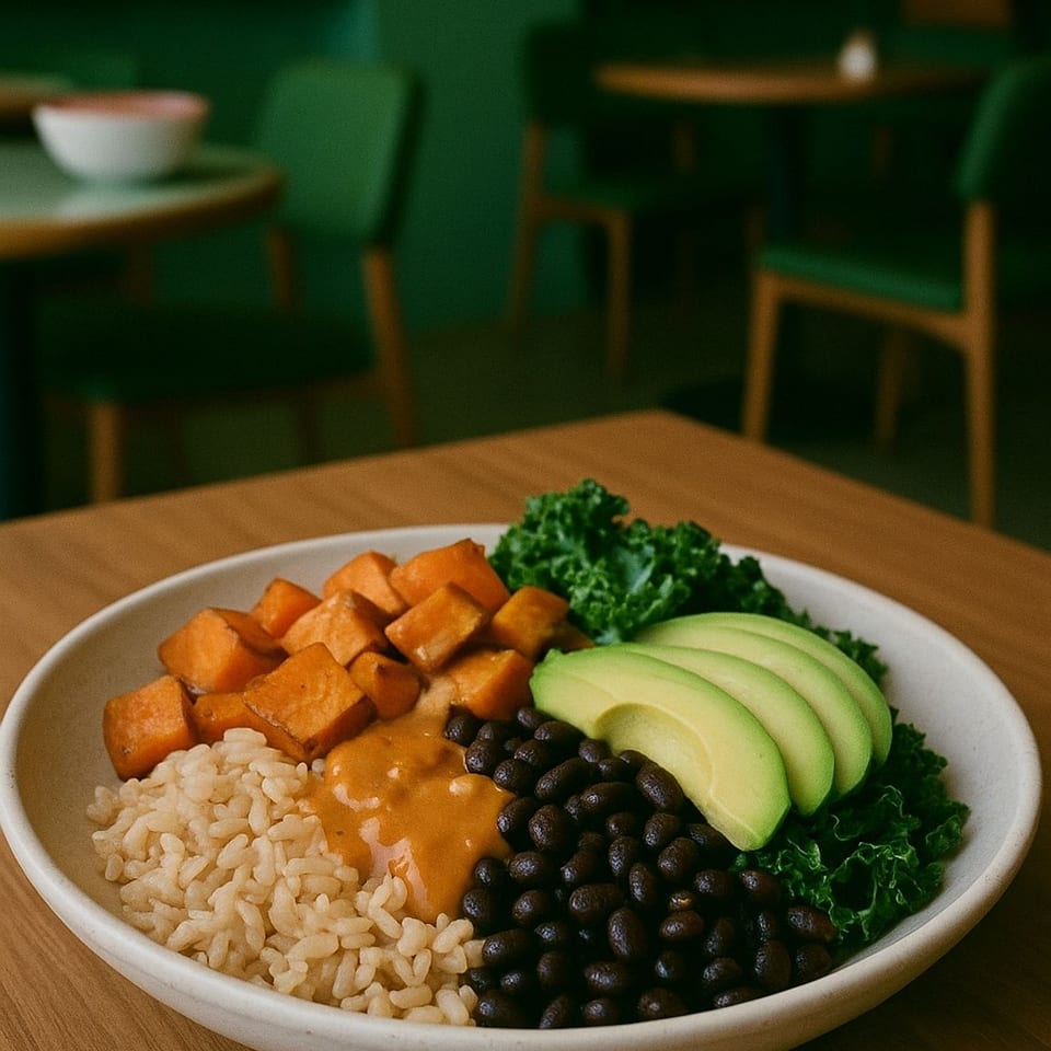 A healthy Love Nutrition bowl with rice, sweet potatoes, black beans, avocado, and kale.